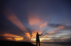 A fisherman casts his line as the sun sets on the outskirts of Havana